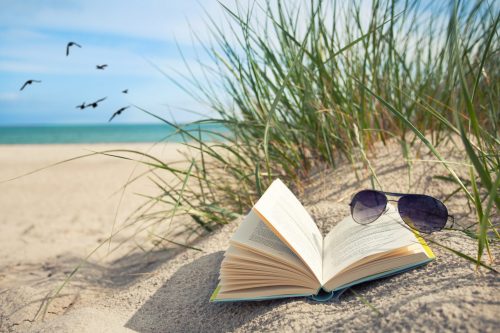book on beach in summer